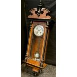 A mid 20th century reproduction walnut cased Vienna clock, enamelled brass face with Roman numerals,
