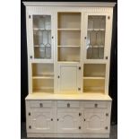 An early 20th century white painted oak kitchen dresser, having an arrangement of cupboards and