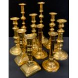A pair of 18th/19th century brass slide action ejector candlesticks; others, assorted shapes and