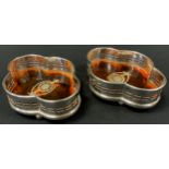 A pair of Edwardian style quarter lobed, faux tortoise shell, bottle coasters (2)