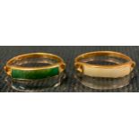 A green stone channel set dress ring possibly jade, yellow metal shank, stamped 750, size M/N;