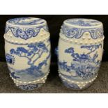 A pair of 20th century Chinese blue and white ceramic barrel stools, decorated with children in