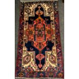 A North West Persian Viz rug / carpet hand-knotted in tones of red, cream, and deep blue, large