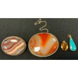 A 9ct gold mounted tigers eye pendant; another turquoise,3.3g gross; banded agate panel brooch,