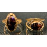 A 9ct gold blue john fluorite oval cabochon dress ring, Sheffield 1972, size O; another size M, 6.7g