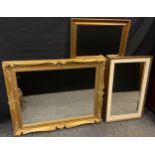 A large ornate gilt framed wall mirror 61cm x 81.5cm glass size; two further wall mirrors, (3).