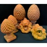 A pair of terracotta finials, as pinecones, 38cm high, another pair conforming smaller; pair of Lion