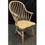 An elm high spindle-back armchair, shaped seat, H-stretcher, turned legs, brass casters, 103cm