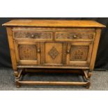 A Titchmarsh and Goodwin style small side board or hall cupboard, over-sailing rectangular top, pair