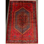 A North West Persian Zanjan rug / carpet, hand-knotted in rich tones of red, burgundy, and blue,