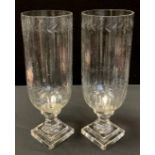 A large pair of reproduction Victorian style cut glass storm lamps, stepped bases, approx. 34cm high