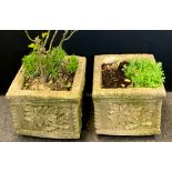 A pair of reconstituted stone square floral cast planters, approx 35cm high, 40cm x 40cm square (2)