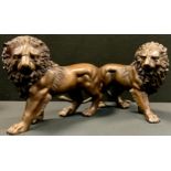 A pair of bronzed metal figures, Walking Lions, each 33cm long (2)