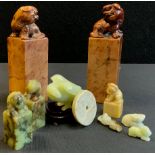 A pair of Chinese green hard stone seal stamps, bear cub terminals; others Qing dynasty style