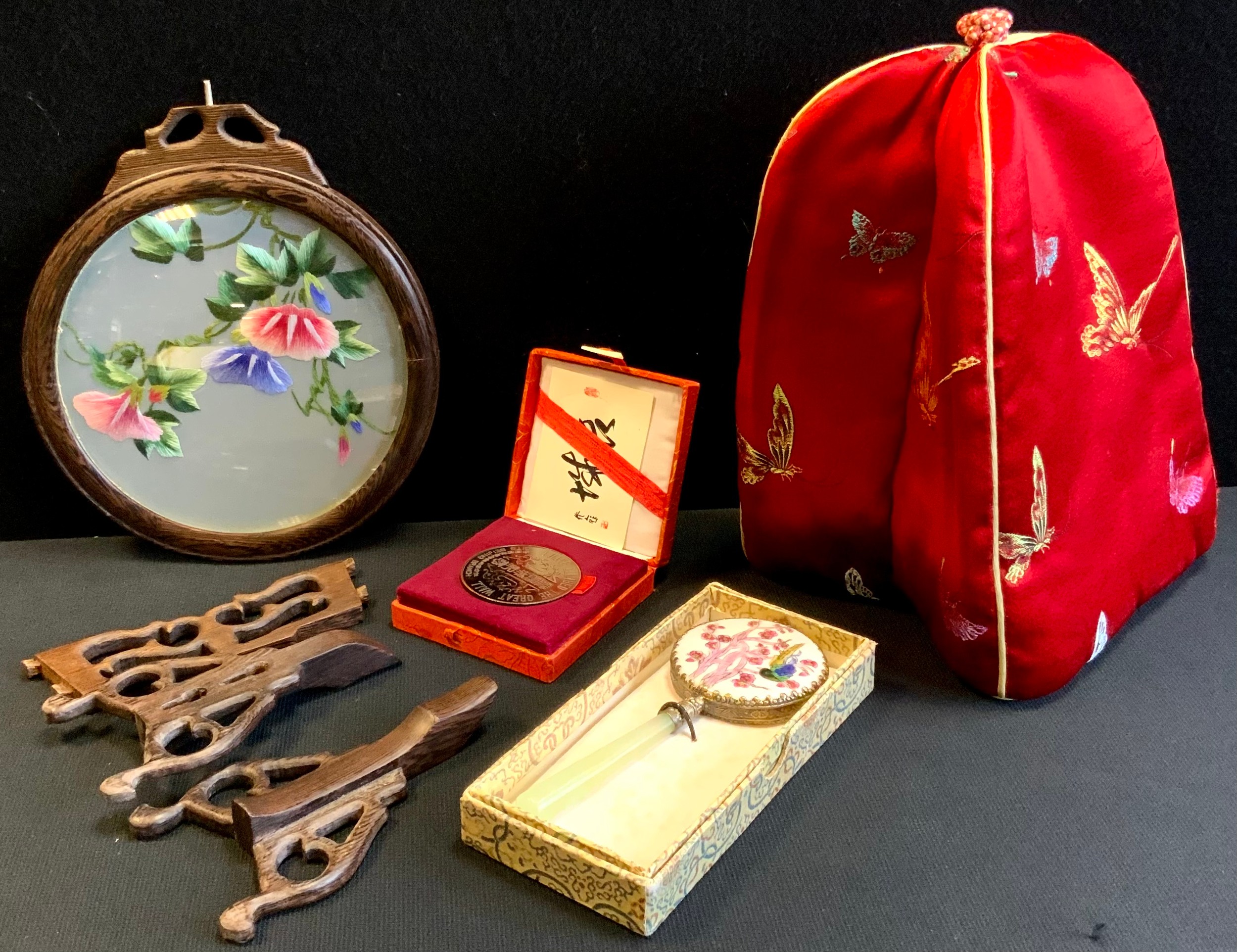 A Chinese swivel table screen, embroidered floral panel, carved stand, boxed; green stone handled