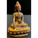 A patinated bronzed metal figure of buddha sitting, 15cm tall