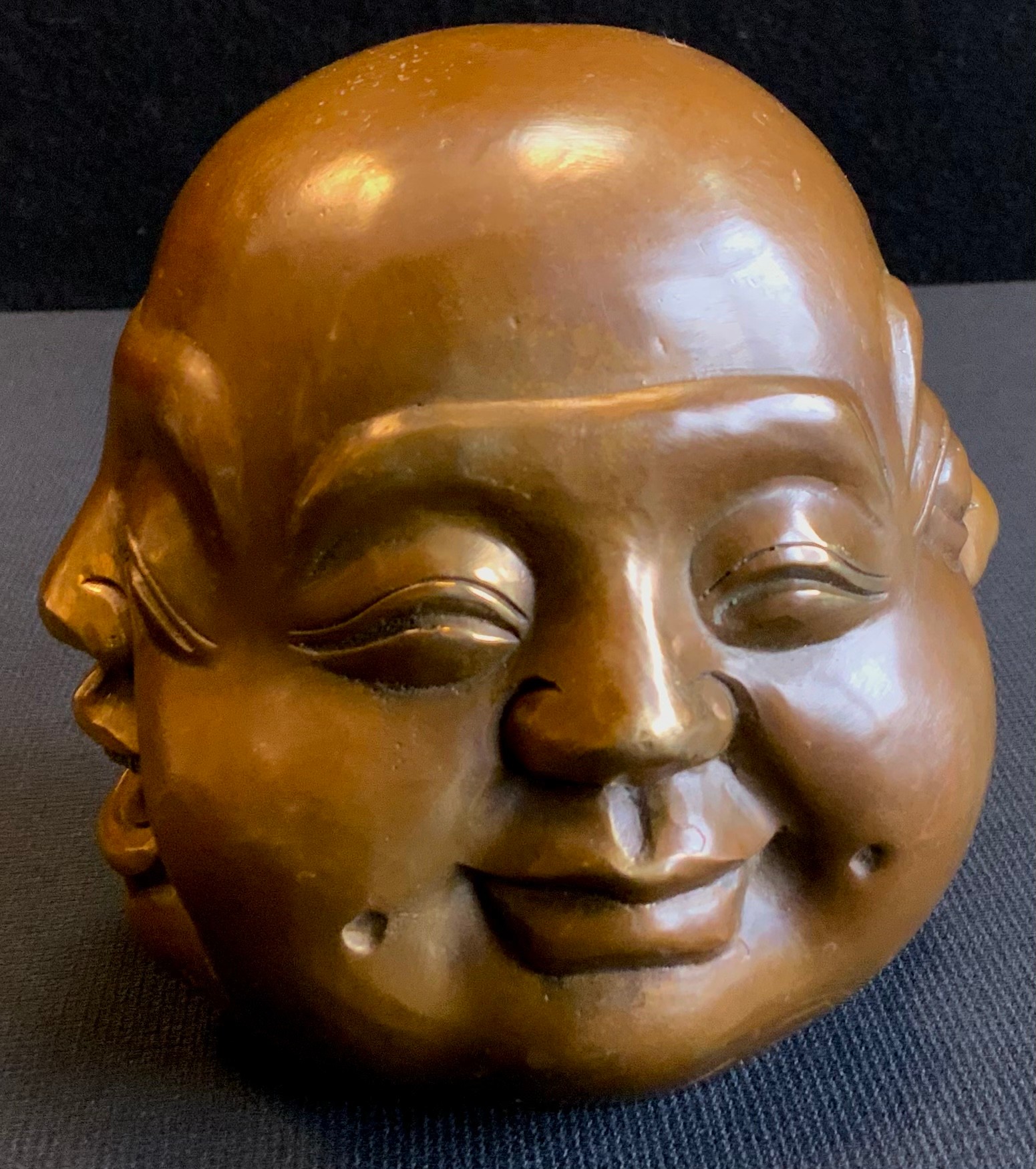 A modern Japanese bronzed coloured head, four faces of buddha paper weight, 12cm high