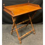 A Victorian mahogany Butler’s tray on beechwood stand, three-quarter galleried tray, turned finials,