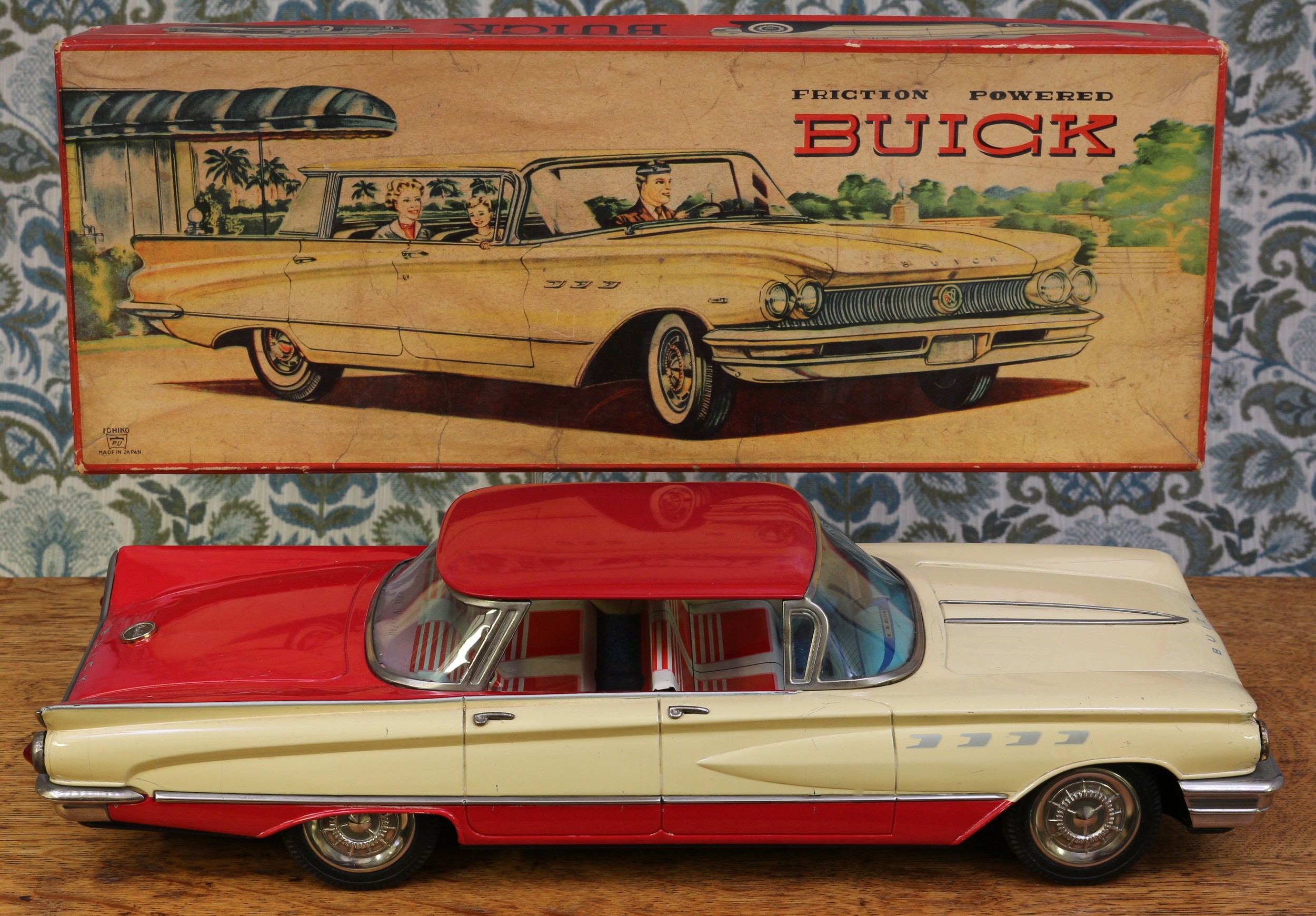 A 1960's Ichiko (Japan) tinplate and friction powered Buick, two tone red and cream body with