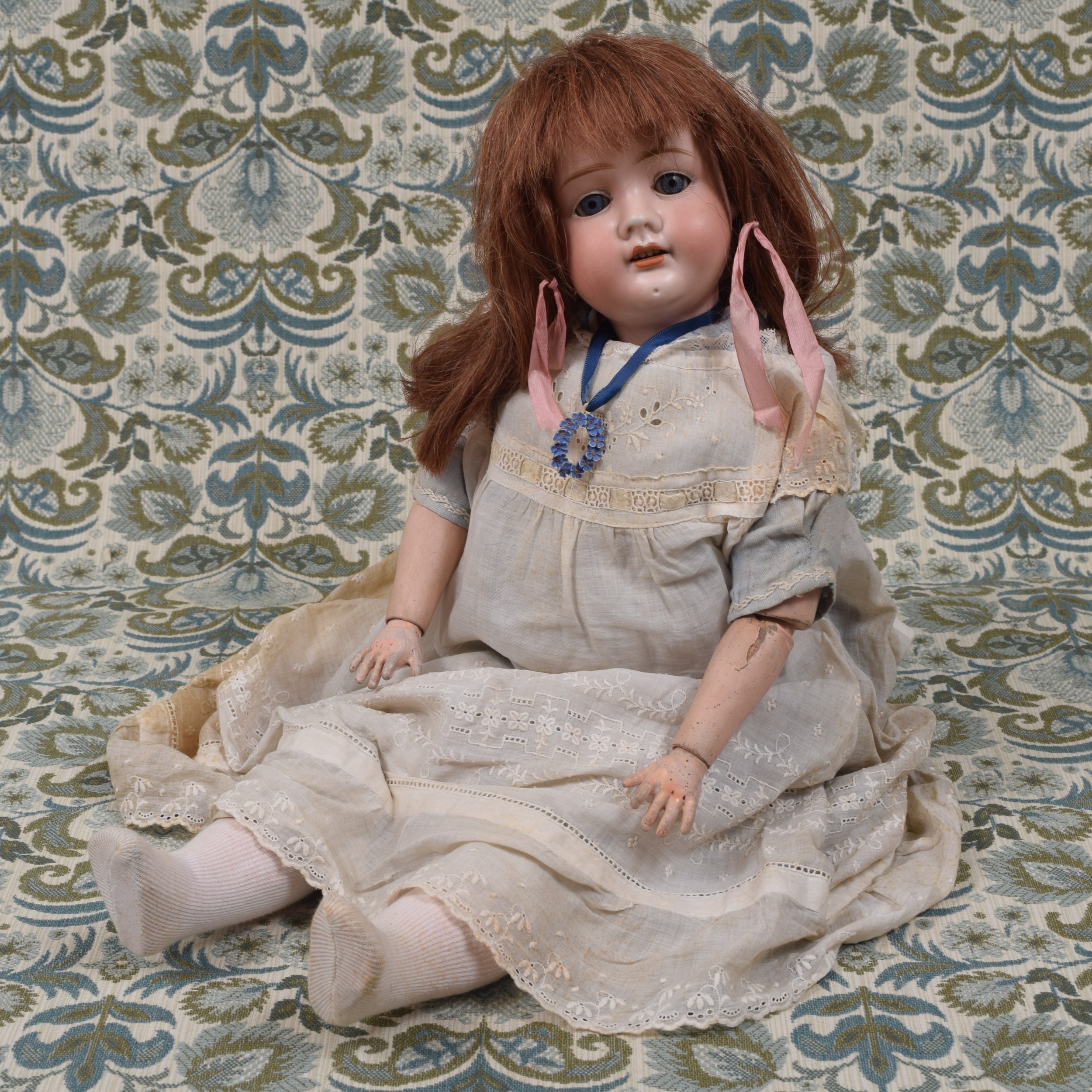 A German bisque head and painted ball jointed composition bodied doll, the bisque head with weighted