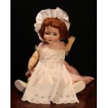 A Carl Harmus (Germany) bisque head and painted composition bodied doll, the bisque head with