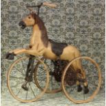 A 'Victorian' style carved wooden and painted child's velocipede tricycle, in the form of a