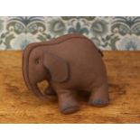 A novelty miniature grey felt Elephant, in the 'Folk Art' manner, amber and black plastic eyes, blue