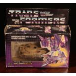 A Hasbro Transformers Triple Changer Blitzwing, comprising snap-on weapons and accessories, window