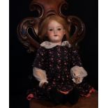 An Armand & Marseille (Germany) bisque head and ball jointed painted composition bodied doll, the