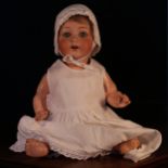 An Armand & Marseille (Germany) bisque head and painted composition bodied doll, the bisque head