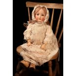 A Cuno & Otto Dressel (Germany) bisque head and ball jointed painted composition bodied doll, the