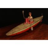 An early 20th century German tinplate and clockwork rowing boat, fitted with a lone oarsman figure