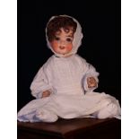 A Heubach Koppelsdorf (Germany) bisque head and painted composition bodied doll, the bisque head