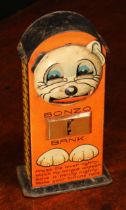 A 1920's/1930's tinplate novelty lever action mechanical money box or bank, Bonzo Bank, lithographed