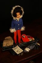 A 1960's Sindy 11½" doll, soft vinyl head with side glancing blue eyes and rooted brunette hair,