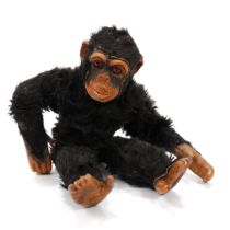 A Dean's 'Tru-to-Life' black mohair Chimpanzee, the moulded rubberised face with amber and black