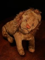 An early 20th century jointed golden mohair Lion, attributed to Steiff (Germany), amber and black
