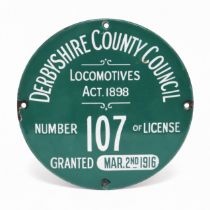 Derbyshire Interest - a single sided circular enamel license plate, white lettering on a green