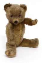 A 1930's Merrythought jointed golden mohair teddy bear, amber and black glass eyes, pronounced snout