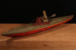An early 20th century German tinplate and clockwork rowing boat, fitted with a lone oarsman figure