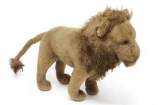 A mid 20th century straw filled golden plush Lion, amber and black plastic eyes, 50cm long, unmarked