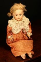 An Armand & Marseille (Germany) bisque shoulder head doll, the bisque shoulder head inset with fixed