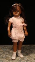 A Götz Sasha Morgenthaler doll with brown hair, wearing a pink shirt with white collar and pink