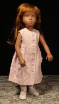 A Götz Sasha Morgenthaler doll with auburn red hair, wearing a pink and white front buttoned dress