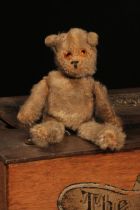 An early 20th century jointed golden mohair miniature teddy bear, amber and black glass eyes,