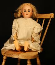 A German bisque head and ball jointed painted composition bodied doll, the bisque head with weighted