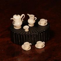 A mid 19th century miniature dolls milk glass tea service, comprising teapot, milk jug, sugar bowl