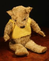 A 1930's jointed golden mohair teddy bear, replacement black boot button eyes, pronounced snout with