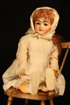 A Simon & Halbig (Germany) bisque head and ball jointed painted composition bodied doll, the