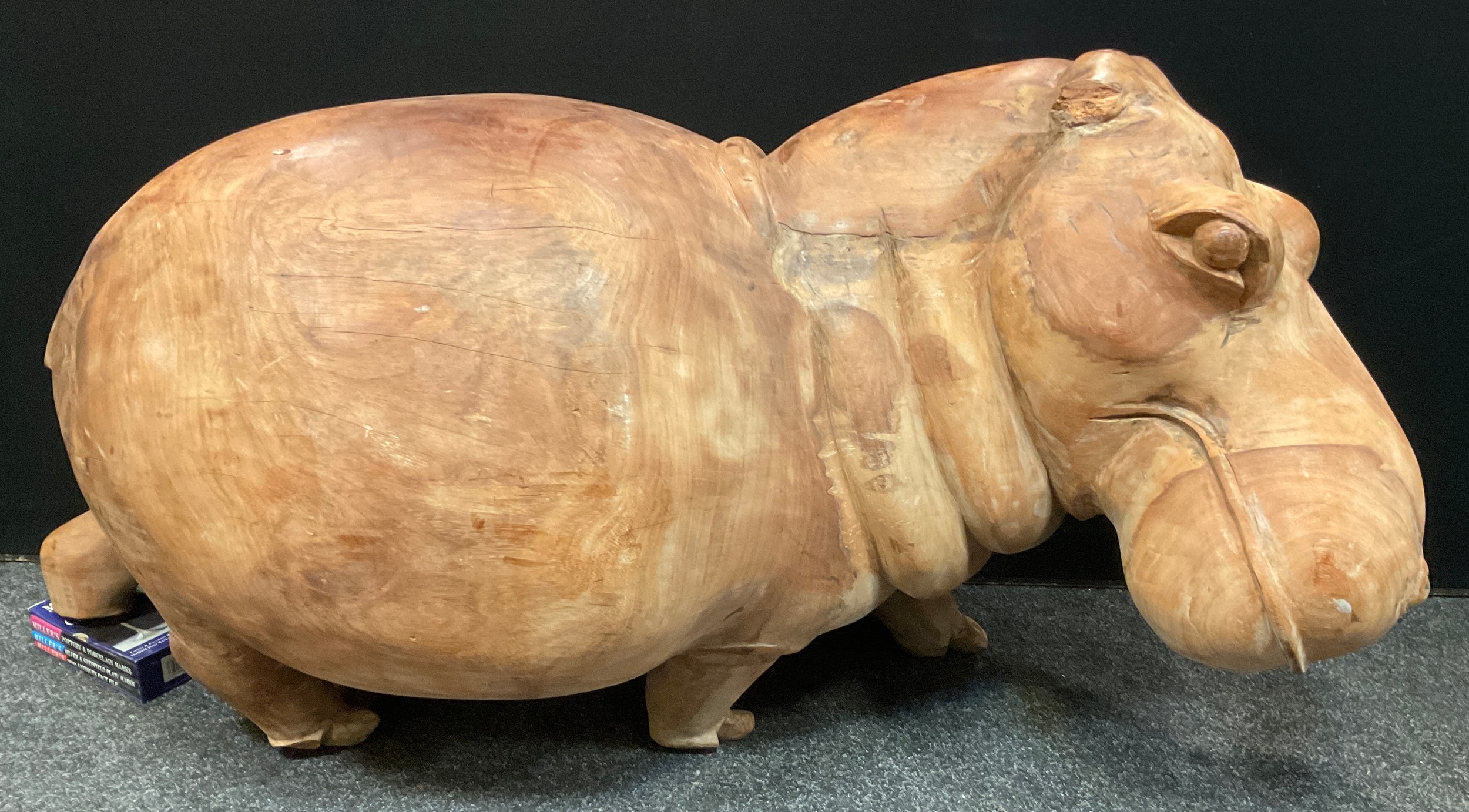 A large African carved hard wood figure, as a Hippopotamus, approx 66cm high, 166cm long, 58cm